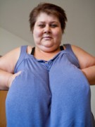 Short-haired mature takes off her blue dress to demonstrate her monster tits