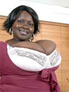 Plump ebony housewife revealing her epic melons on the sofa.