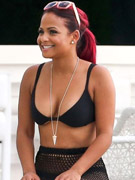 Ponytailed and relaxed christina milian looking sexy in a bikini and fishnet skirt