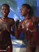 Naughty black tropical gals in g strings soiling each other with paints while having wild lesbian games