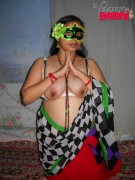 Busty indian housewife in a colorful sari and mask demonstrating her cunt and boobs