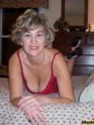 Drop dead gorgeous granny in her red lingerie shows her hotness in bed as she tickles her pussy for sensual satisfaction
