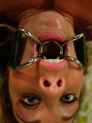 Red gagballed vixen with clamps on her nipples banged roughly by a masked man